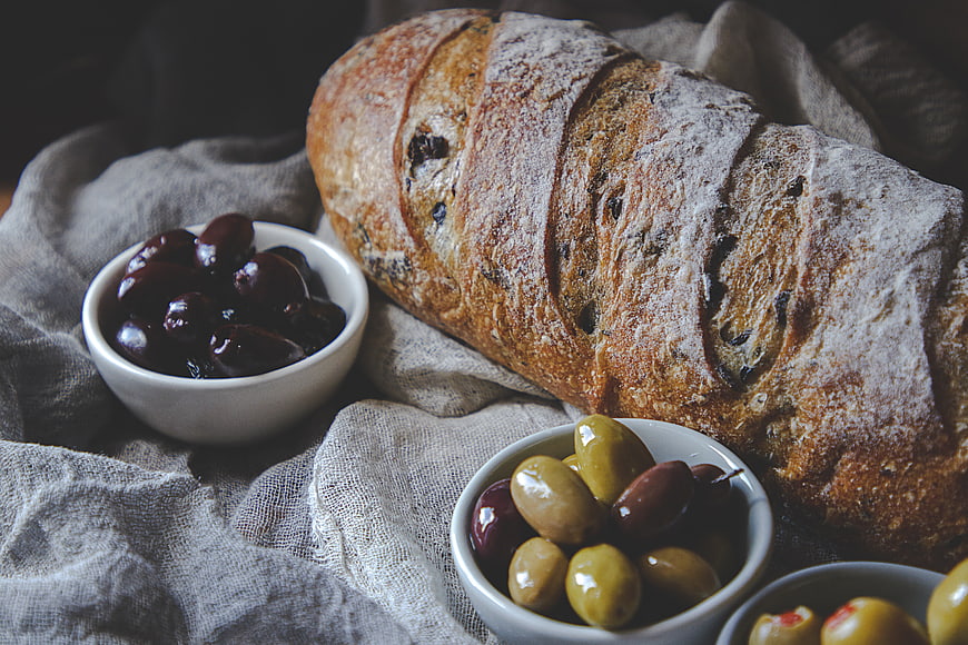 Rustic Sourdough Bread with Olives on Linen