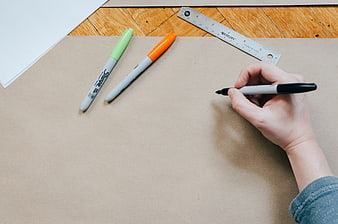 Hand drawing on cardboard with markers and ruler