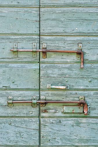 Rusty Iron Latches on Weathered Green Wooden Door