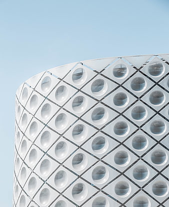 Modern white building facade with circular windows