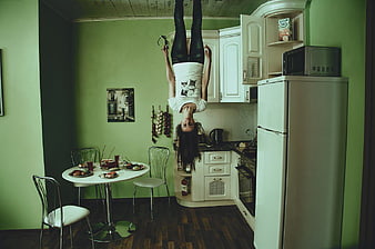 Upside Down Woman Hanging from Kitchen Ceiling