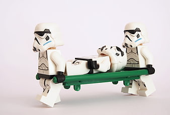 Lego Stormtroopers Carrying Wounded Comrade on Green Stretcher