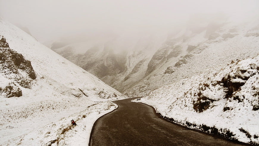 Winding Mountain Road Through Snowy Foggy Valley
