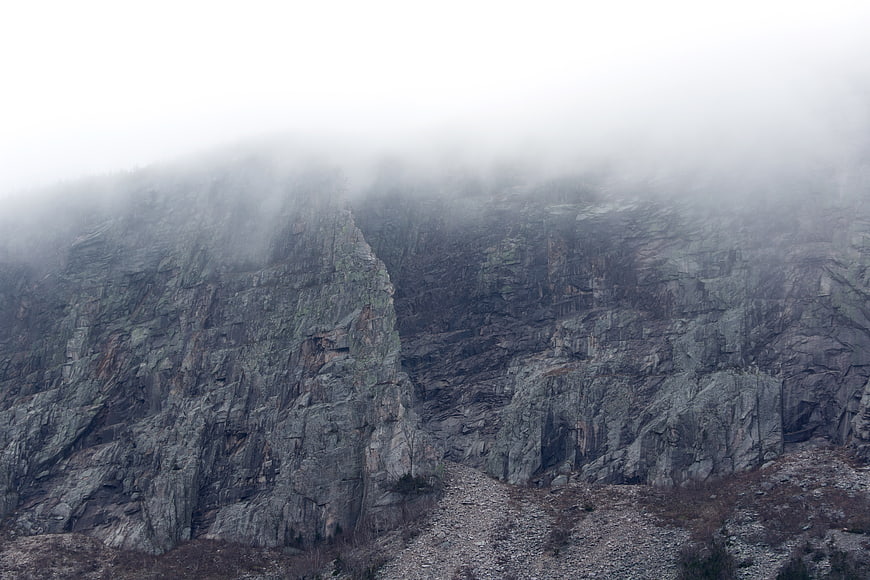 Misty rocky mountain cliff landscape with fog
