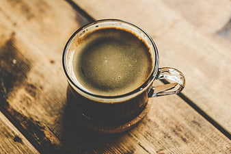 Top View of Black Coffee in Glass Mug on Wooden Table