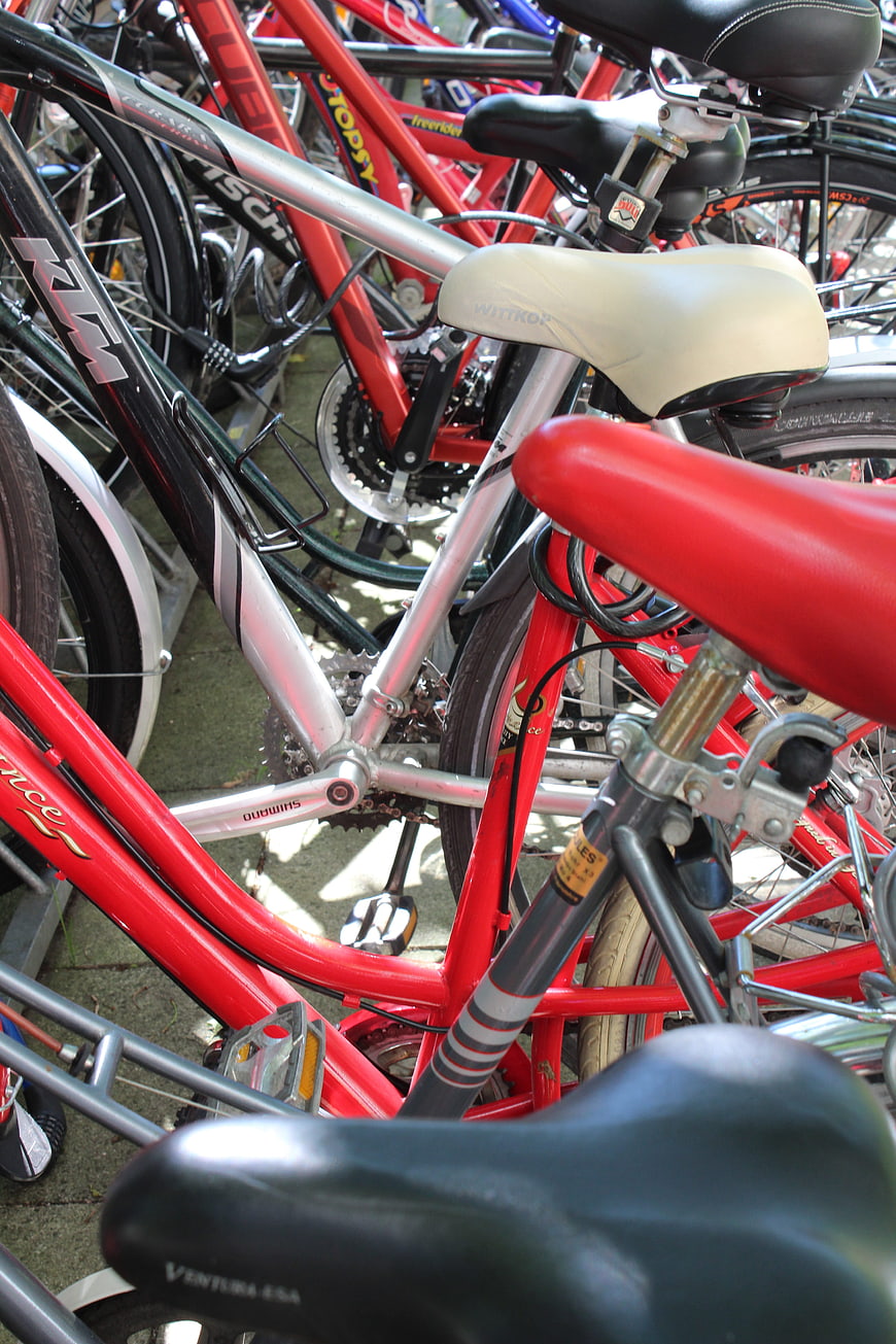 Close-up of parked bicycles with red and silver frames