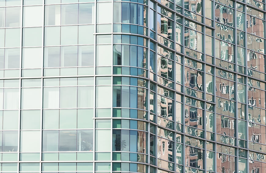 Modern Glass Office Building Facade with Reflections
