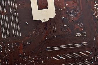 Close-up of brown computer motherboard circuit board