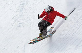 Skier in Red Jacket Jumping on Snowy Slope