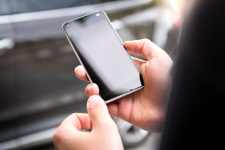 Close-up of Hands Holding Smartphone with Blank Screen