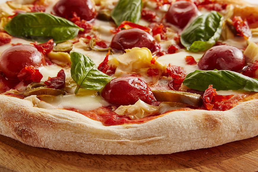 Close-up of Italian pizza with cherry tomatoes and basil