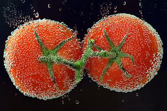 Two Fresh Tomatoes in Carbonated Water