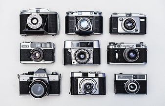 Collection of vintage analog film cameras on white background