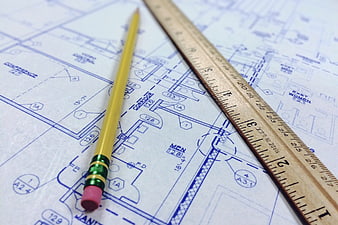Yellow Pencil and Wooden Ruler on Architectural Blueprint