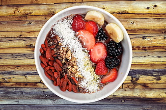 Overhead view of healthy acai bowl with fresh berries and granola