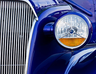 Close-up of Classic Blue Car Headlight and Chrome Grille