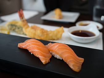 Salmon Nigiri Sushi and Tempura on Black Plate