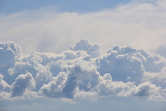 Dramatic Cumulus Clouds in Blue Sky with Sunbeams
