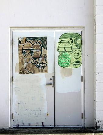 Urban street art graffiti on white double doors