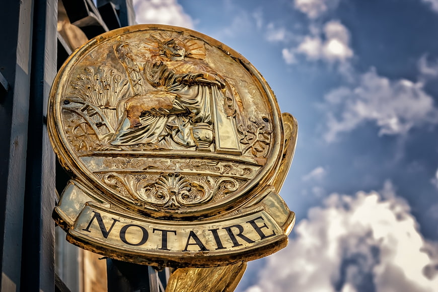 Golden Notaire Signage Emblem Against Blue Sky
