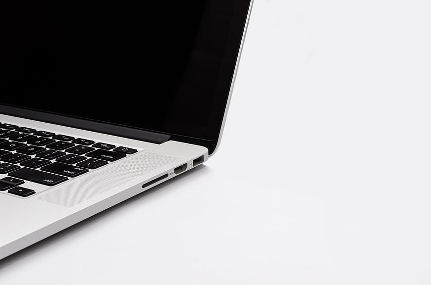 Close-up of Silver Laptop Keyboard and Ports on White Background