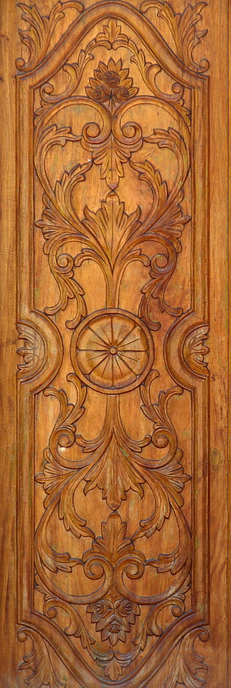 Close-up of ornate carved wooden door panel with floral design