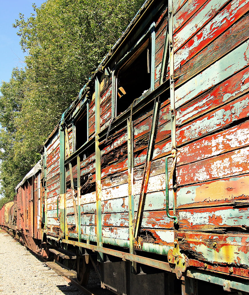 Weathered Wooden Train Car In Abandoned Rail Yard