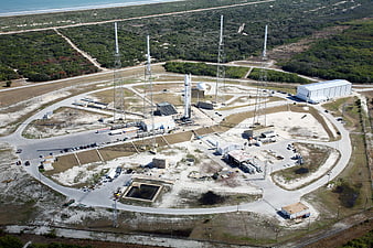 Aerial view of rocket launch pad near coast