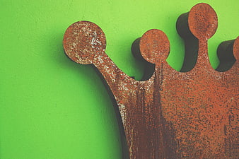 Rusty Metal Crown on Bright Green Wall