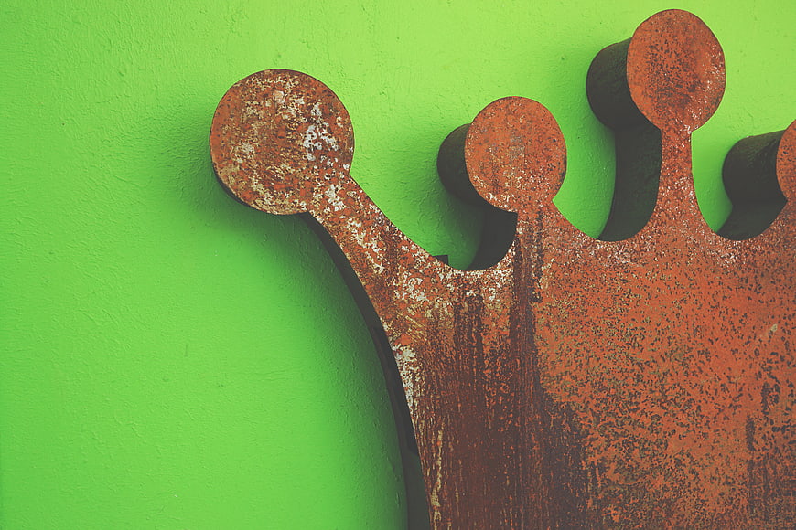 Rusty Metal Crown on Bright Green Wall