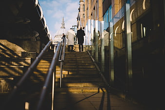 Two People Walking Up Stairs Towards St Paul's Cathedral