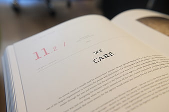 Close-up of Open Book Page with Text We Care