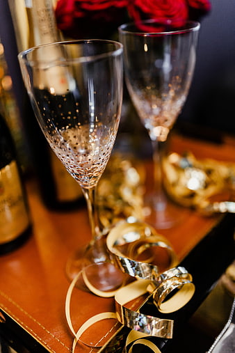 Empty champagne flutes with gold confetti for New Year's Eve