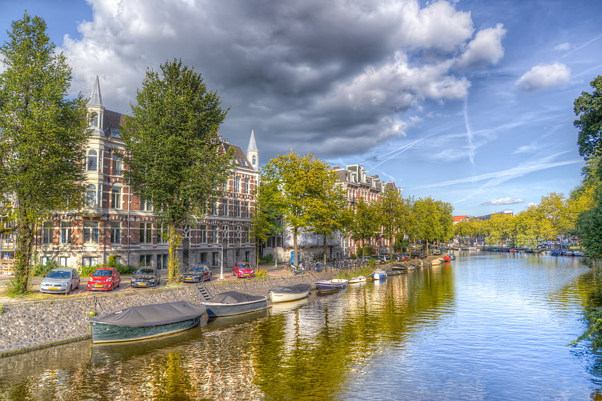 Scenic Amsterdam Canal with Boats and Architecture
