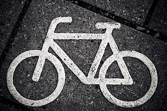 White Bicycle Symbol Painted on Asphalt Road Surface