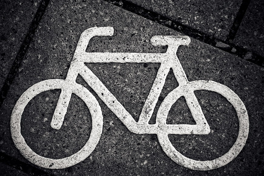 White Bicycle Symbol Painted on Asphalt Road Surface