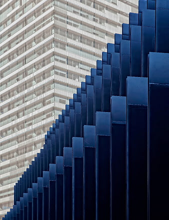 Modern Blue Geometric Architecture Against White Skyscraper