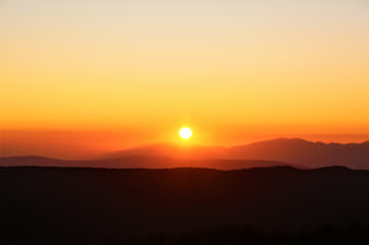 Sunset Over Silhouetted Mountain Ranges