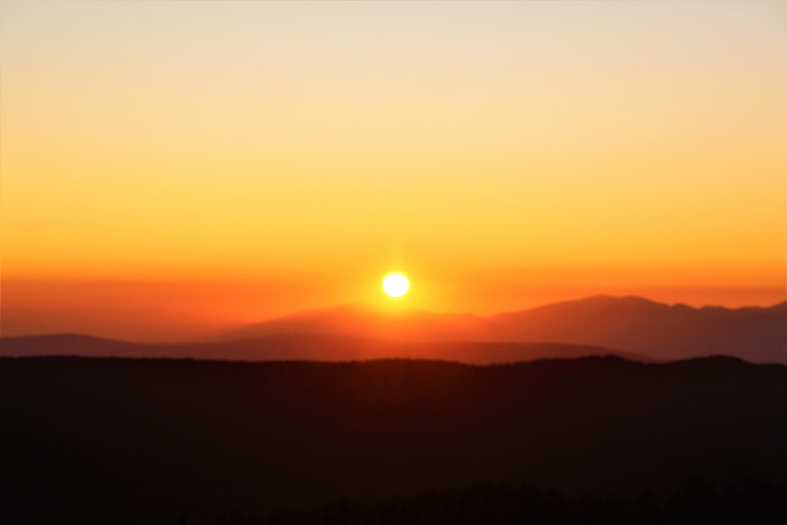 Sunset Over Silhouetted Mountain Ranges
