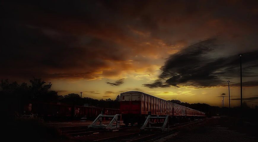 Dramatic Sunset Over Freight Train Tracks