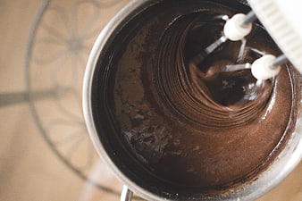 Top view of chocolate batter being mixed in a metal bowl