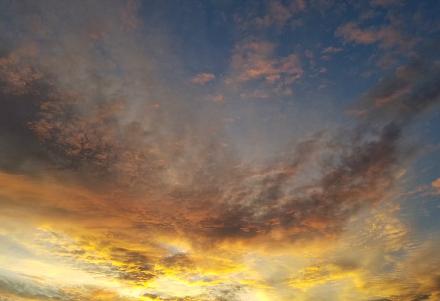 Dramatic sunset sky with golden clouds and blue tones