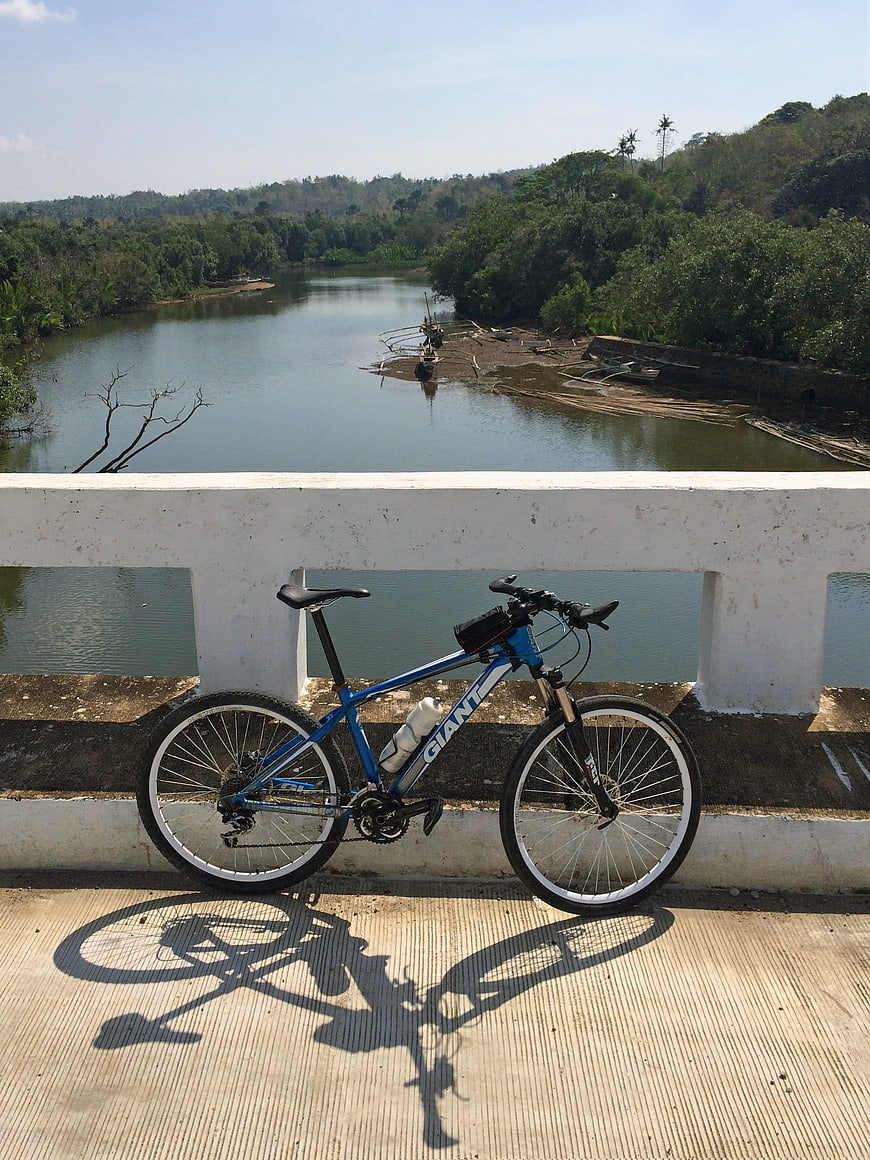 Blue mountain bike on bridge overlooking river
