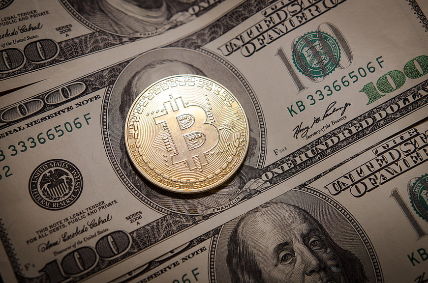 Bitcoin Coin On US Dollar Bills