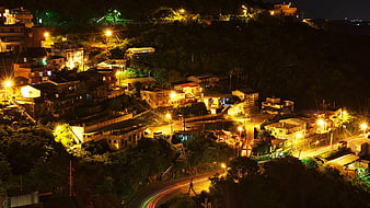 Nighttime Hillside Village with Long Exposure Light Trails