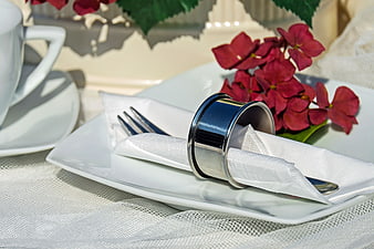 Elegant Table Setting with Silver Napkin Ring and Red Flowers