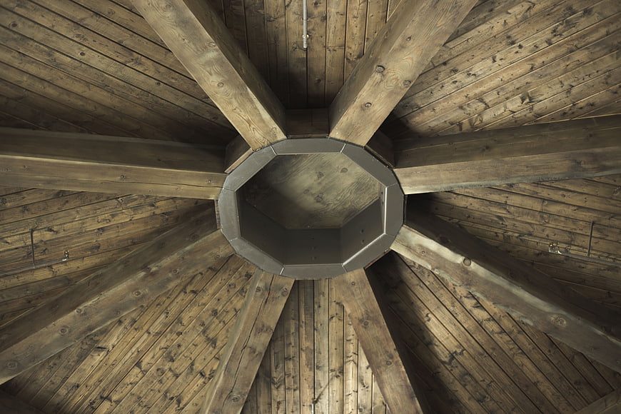 Octagonal wooden ceiling with radial beams and central vent