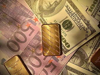 Gold Bars on US Dollars and Euro Banknotes