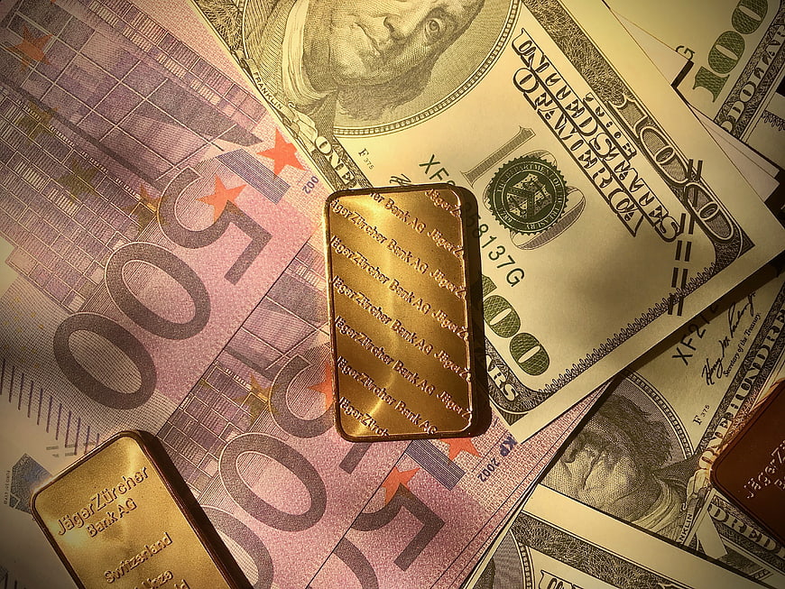 Gold Bars on US Dollars and Euro Banknotes