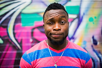 Portrait of African American Man in Front of Colorful Graffiti Wall